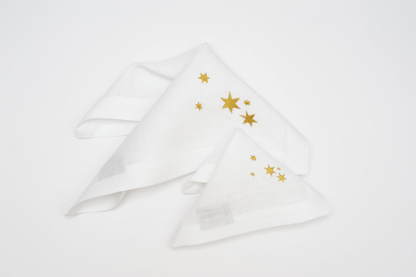Winter Whispers: Linen White Embroidered Table Napkins with Festive Designs